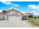 Single-story home with a well-manicured front yard, spacious driveway, and attached two-car garage exudes suburban charm at 2829 Forrest Duke Ct, Las Vegas, NV 89108