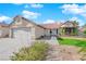 Inviting single-story home with drought resistant landscaping, a two car garage, and tile roofing at 2829 Forrest Duke Ct, Las Vegas, NV 89108