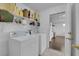 Convenient laundry room with washer, dryer, and storage shelves with views to the kitchen at 2829 Forrest Duke Ct, Las Vegas, NV 89108