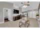 Open-concept living room with tile floors, vaulted ceiling, and a ceiling fan at 2829 Forrest Duke Ct, Las Vegas, NV 89108