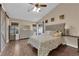 Bright main bedroom with ceiling fan, wood-look floors and a large dresser at 2829 Forrest Duke Ct, Las Vegas, NV 89108