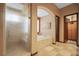 Elegant bathroom with a frosted glass shower, soaking tub, and custom tile flooring at 36 Avenida Fiori, Henderson, NV 89011