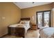 Cozy bedroom with warm tones, plush bedding, and access to outdoor patio at 36 Avenida Fiori, Henderson, NV 89011