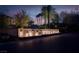Entrance to gated Porta Ciela community features a stone sign with lights and mature desert landscaping at dusk at 36 Avenida Fiori, Henderson, NV 89011