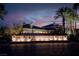Stone community sign and tropical landscaping at dusk highlighting luxury community at 36 Avenida Fiori, Henderson, NV 89011