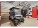 Well organized garage with a golf cart and bicycles hanging from the ceiling at 36 Avenida Fiori, Henderson, NV 89011