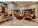 Spacious living room with travertine floors, a bar area, and open access to other living areas at 36 Avenida Fiori, Henderson, NV 89011