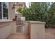 Built-in outdoor kitchen with a stainless steel grill and granite countertop for alfresco dining and entertaining at 36 Avenida Fiori, Henderson, NV 89011