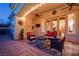 Cozy outdoor living space with ceiling fans, a stone fire pit, comfortable seating, and a tranquil ambiance at 36 Avenida Fiori, Henderson, NV 89011