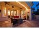 Charming outdoor living area with comfortable seating around a stone fire pit and views to indoor spaces at 36 Avenida Fiori, Henderson, NV 89011