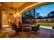 Relaxing outdoor living space with comfortable seating, a fire pit, and views to the pool area beyond at 36 Avenida Fiori, Henderson, NV 89011