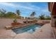 Inviting private pool and spa with stone accents, lush landscaping, and outdoor seating area at 36 Avenida Fiori, Henderson, NV 89011