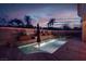 Tranquil twilight view of pool with integrated water feature and lush tropical landscaping at 36 Avenida Fiori, Henderson, NV 89011