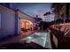 An inviting pool area includes a patio, bar, and ambient lighting for evening enjoyment at 36 Avenida Fiori, Henderson, NV 89011