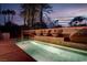 Inviting pool area featuring custom water feature wall and lush palm trees at 36 Avenida Fiori, Henderson, NV 89011