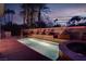 Inviting pool and spa with a unique water feature and professional landscaping under an evening sky at 36 Avenida Fiori, Henderson, NV 89011