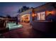 An inviting outdoor area featuring a pool, patio, outdoor kitchen, and warm exterior lighting at 36 Avenida Fiori, Henderson, NV 89011