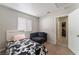 Cozy bedroom with a bed, couch, and access to a hallway at 4634 Skybolt St, Las Vegas, NV 89115