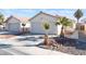 House exterior featuring a two-car garage and desert landscaping at 4634 Skybolt St, Las Vegas, NV 89115
