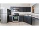 Kitchen boasts stainless steel appliances and dark wood cabinets at 4634 Skybolt St, Las Vegas, NV 89115