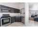 Modern kitchen featuring dark cabinetry, stainless steel appliances, and granite countertops at 4634 Skybolt St, Las Vegas, NV 89115