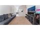 Living room with sectional sofa, large TV, and view to dining area at 4634 Skybolt St, Las Vegas, NV 89115