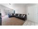 Spacious living room with a large sectional sofa and carpet flooring at 4634 Skybolt St, Las Vegas, NV 89115