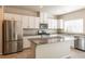 Modern kitchen with island, stainless steel appliances, and granite countertops at 487 Via Renata, Henderson, NV 89044