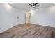 Bright bedroom featuring wood-look flooring and an ensuite bathroom at 5061 Pioneer Ave # 104, Las Vegas, NV 89146