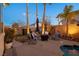 Relaxing backyard oasis with a sparkling pool, patio furniture, and fire pit at 8065 Lapis Harbor Ave, Las Vegas, NV 89117