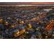 Aerial view showcases a residential neighborhood with well-maintained homes and street lighting at dusk at 9331 Hilgard Ave, Las Vegas, NV 89178