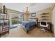 Comfortable bedroom with a sliding glass door to backyard and wall-mounted shelves at 9331 Hilgard Ave, Las Vegas, NV 89178