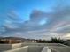 Rooftop view of city lights and mountains under a cloudy blue sky at 9331 Hilgard Ave, Las Vegas, NV 89178