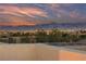 Expansive city and mountain views under a colorful sunset sky, showcasing the property's location at 9331 Hilgard Ave, Las Vegas, NV 89178