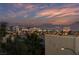 Striking panoramic view of the city skyline and distant mountains under a vibrant sky at sunset at 9331 Hilgard Ave, Las Vegas, NV 89178