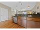 Well-lit kitchen features wood cabinets, stainless steel dishwasher, and open layout at 9331 Hilgard Ave, Las Vegas, NV 89178