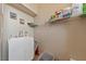 Bright laundry room with a utility sink, white cabinets, and ample shelving at 9331 Hilgard Ave, Las Vegas, NV 89178