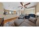 Cozy living room featuring a ceiling fan, pendant lighting, and hardwood floors at 9331 Hilgard Ave, Las Vegas, NV 89178