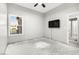 Well-lit bedroom with window, mounted TV and ceiling fan at 10077 Clifton Forge Ave, Las Vegas, NV 89148