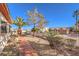 Landscaped side yard with a pathway, mature plants, and rock ground cover at 1046 Weatherboard St, Henderson, NV 89011