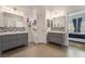 Double vanity bathroom with gray cabinets and mosaic tile at 10521 Ettenmoor Ave, Las Vegas, NV 89135