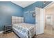 Bedroom with gray headboard, blue walls, and floral bedding at 10521 Ettenmoor Ave, Las Vegas, NV 89135