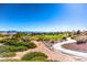 Scenic view of a golf course with a winding road and mountain backdrop at 11000 Mckendrec Ct, Las Vegas, NV 89134