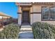 Dark brown front door entry with decorative gate and landscaping at 1132 Highbury Grove St, Henderson, NV 89002