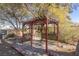 Backyard pergola with wooden deck and landscaping at 1200 Cashman Dr, Las Vegas, NV 89102