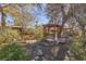 Landscaped backyard with stone pathway, lush plants, and a wooden pergola at 1200 Cashman Dr, Las Vegas, NV 89102
