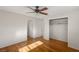 Hardwood floor bedroom with ceiling fan and access to hallway at 1200 Cashman Dr, Las Vegas, NV 89102