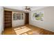 Bright bedroom with hardwood floors, built-in shelves, and ceiling fan at 1200 Cashman Dr, Las Vegas, NV 89102