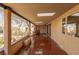 Long covered patio with red flooring and access to the backyard at 1200 Cashman Dr, Las Vegas, NV 89102