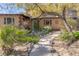 Ranch house with mature trees and landscaped walkway at 1200 Cashman Dr, Las Vegas, NV 89102